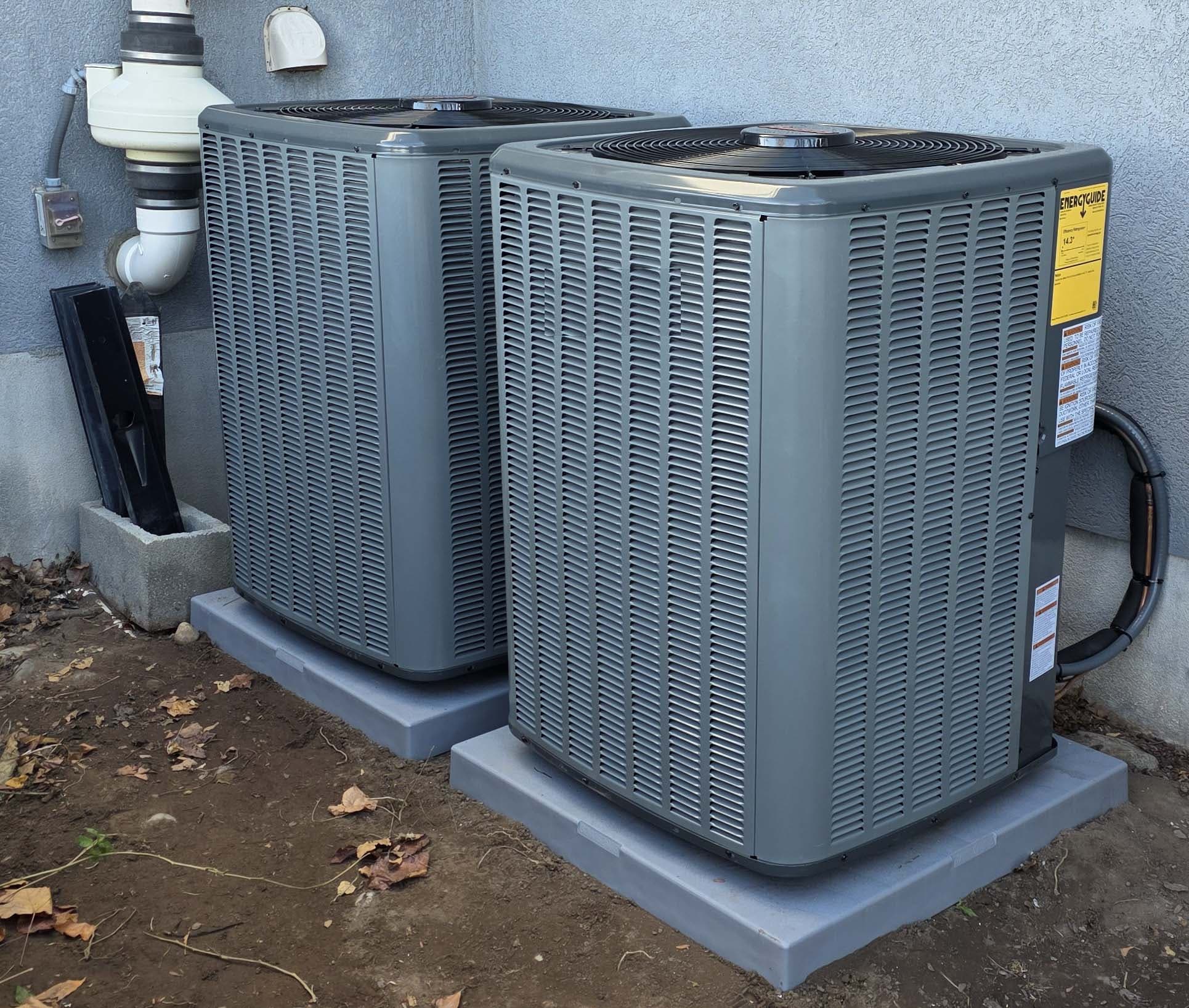 Two outdoor AC condensers β side-yard install on level pads