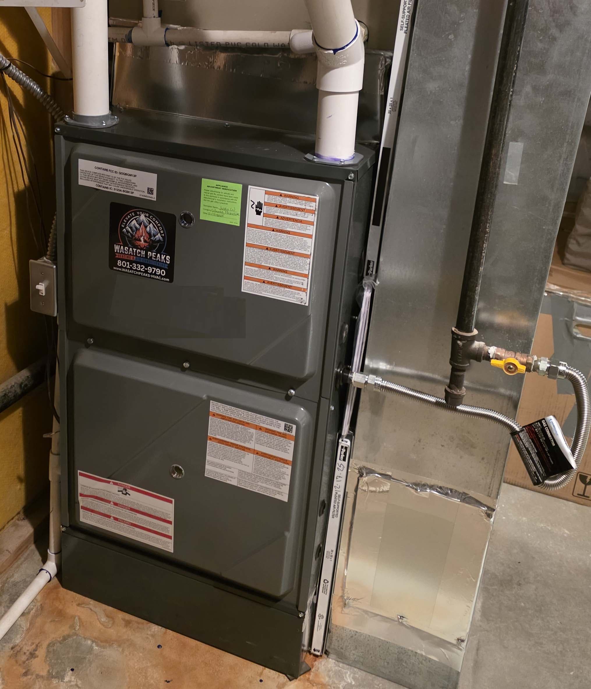 High-efficiency furnace install with Wasatch Peaks branded service tag
